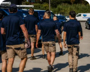Plumbers walking to their service vans on a Acacia Gardens job